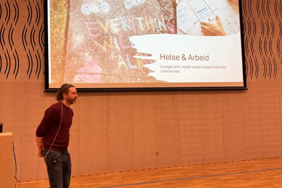 En mann som står foran en projeksjonsskjerm